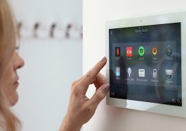 Woman using wall mounted home automation console