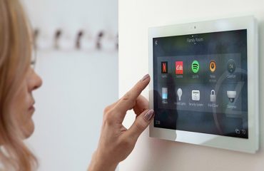 Woman using wall mounted home automation console